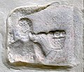 English: Eros with Cornucopia (CSIR II/4, 352) on a grave relief at the south wall Deutsch: Eros mit Früchtekorb auf einem Reliefstein (CSIR II/4, 352) an der S-Wand