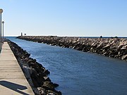 The outfall of Quarteira river into the Atlantic ocean at the entrance to Vilamoura marina which is in the municipality of Loulé, Algarve, Portugal.