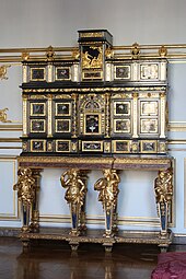 Cabinet with caryatids; c.1675; ebony, kingwood, marquetry of hard stones, gilt bronze, pewter, glass, tinted mirror and horn; unknown dimensions; Musée des Arts décoratifs, Strasbourg, France[123]