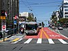 A bus stop with bus in the median of an urban arterial