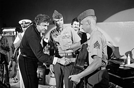 Johnny Cash receives an award from a Marine sergeant.jpg