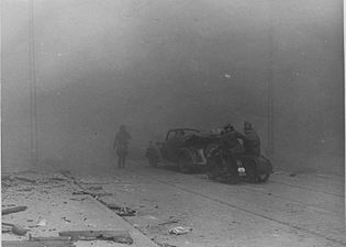 IPN copy #24 (No caption) Zamenhofa Street between Wołyńska and Miła looking North, with burning Zamenhofa 29, 31 and 33 on the left.