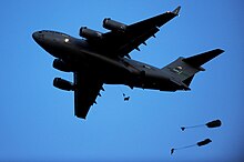 Two paratroopers dropping from a C-17 during an exercise