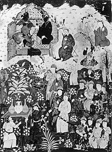 Black and white image of a courtly scene, with large numbers of people surrounding a couple on a bench