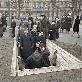 Finnish civilians enter a bomb shelter in Helsinki during the Winter War, 1939