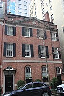 A brick house with a peaked roof