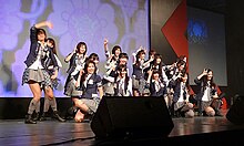 Smiling girls gesturing onstage