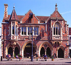 View south along the High Street showing the town hall, shops and market stalls