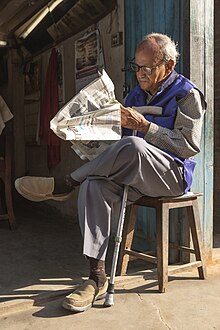 Old man reading newspaper early in the morning at Basantapur-IMG 6800.jpg