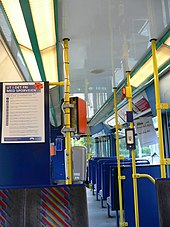 A row of seats facing forwards in a tram, with a door hidden to the right