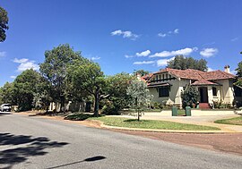 Street with houses and trees on side