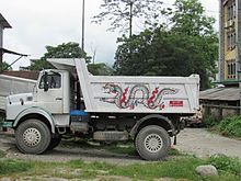 Small dump truck with a dragon painted on the side