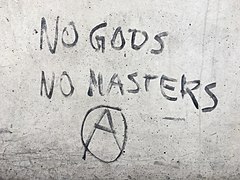 Graffiti "No Gods, No Masters" and anarchy symbol at central bus station ZOB in Munich, Germany.jpg