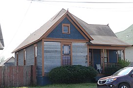 Old and new: house with car in Marshall Square Historic District