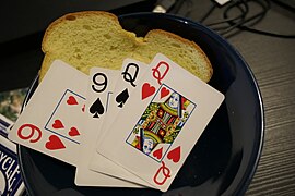 Bread in bowl with playing cards with a little less box visible outside.jpg