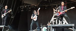 Fall Out Boy performing at Rock im Park in 2014. From left to right: Joe Trohman, Patrick Stump, Andy Hurley, and Pete Wentz.