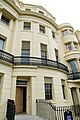 The Exterior of 13 Brunswick Square. The early glass was fragile and storm shutters protected the glass from stones blown up during storms.[1]