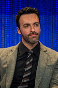 Reid Scott interprète Eli.