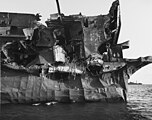 View of the USS Independence's port quarter showing severe blast damage caused by the "Able Day" atomic bomb air burst over Bikini Atoll on July 1, 1946