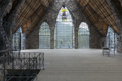 Arched windows with a mountain view inside Bishop Castle.