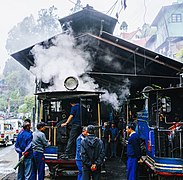 Men standing around a steam locomotive in a shed