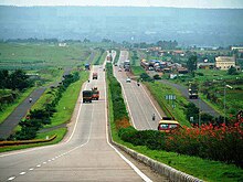 Landscaped four-lane road over rolling terrain