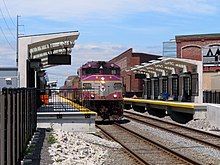 A train passing through a station in an urban area