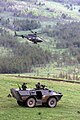 A US Army (USA) OH-58D Kiowa Warrior helicopter provides close air support for Portuguese Army Soldiers aboard a Chaimite V-200