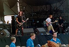 People on a stage performing with instruments