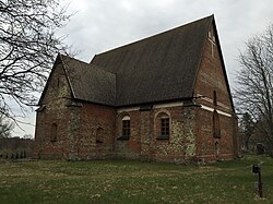 Brick building with steep roof and Gothic windows