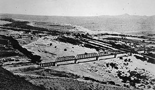 View, looking northeast from Tempe Butte, Salt River railroad bridges, ca. 1900