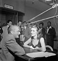 Beryl davis with artists as Georgie Auld, Ray McKinley, Mary Lou Williams, Josh White and others visible in the background