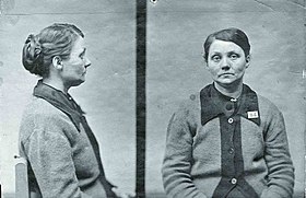 Police mugshots in black and white of middle-aged woman sitting on a chair wearing a cardigan and looking listlessly into the camera