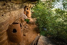 Adobe granaries line the face of cliff