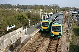 Two trains alongside each other at a station