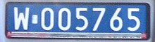 A dark blue plate reading W005765