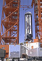 The Saturn I S-I stage for the SA-1 mission was being eased into place and erected on the launch pad at Cape Canaveral