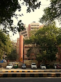 alt=Building with trees and parked cars