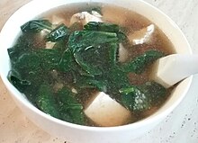 A bowl of Chinese style spinach and tofu soup, typically referred as "emerald and white jade soup"