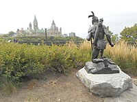 Anishinaabe Scout from rear, with the Parliament Hill in the background