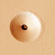 HiRISE image (color) of a 35 m wide lava tube skylight surrounded by a collapse pit on Pavonis Mons