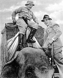 Buck, climbing out of a wicker howdah, with John Ringling North