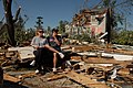 Man and woman sitting among their devastated home in the Forest Park neighborhood, Springfield, Massachusetts