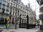 Vintage entrance to subte Line A of the Buenos Aires Metro on Avenida de Mayo; behind it, City Hall