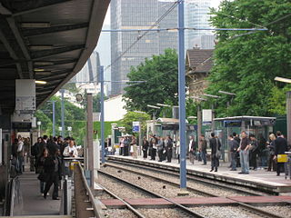 Les quais de la station du tramway (à l'arrière-plan, La Défense).