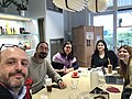 5 smiling people at a table with coffee drinks