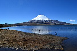 A black lava flow almost reaches the lake