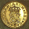 Reverso de moneda de 1/2 escudo (oro) de Fernando VI con "ceca" de Madrid del año 1750.