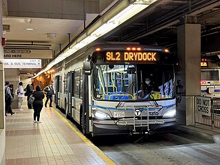 A silver-colored bus at an underground bus stations