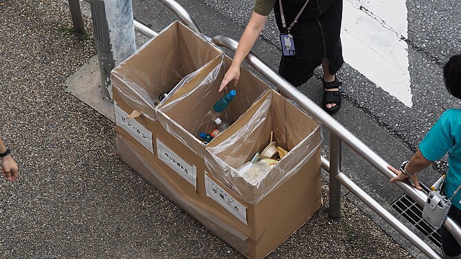 Temporary separate trash cans set up at an outdoor event in Japan